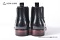 Prada Classic Brushed Black Calfskin Boot with the Iconic Enameled Metal Triangle Logo