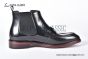 Prada Classic Brushed Black Calfskin Boot with the Iconic Enameled Metal Triangle Logo