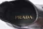 Prada Classic Brushed Matte Black Calfskin Boot with the Iconic Enameled Metal Triangle Logo