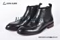 Prada Classic Smooth Matte Black Calfskin Boot with the Iconic Enameled Metal Triangle Logo