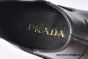 Prada Classic Smooth Matte Black Calfskin Boot with the Iconic Enameled Metal Triangle Logo